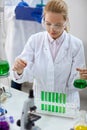 Female scientist with pipette and tubes making test Royalty Free Stock Photo