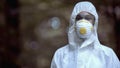 Female scientist in protective uniform and mask looking at camera, template Royalty Free Stock Photo