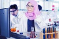 Female scientist showing thumb up in laboratory