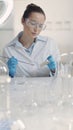Female Scientist Streaking Bacterial Culture with Inoculation Loop in Laboratory Royalty Free Stock Photo