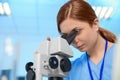 Female scientist using microscope in chemistry laboratory Royalty Free Stock Photo