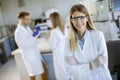 Female scientist in white lab coat standing in the biomedical lab Royalty Free Stock Photo