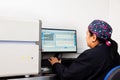 Female scientist working at the laboratory with a thermal cycler. Real-time polymerase chain reaction technique. RT-PCR technique