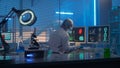 A female scientist works at a computer and checks the data of analyzes. A female researcher against the backdrop of a