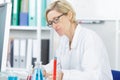 Female scientist writing report on science experiments Royalty Free Stock Photo