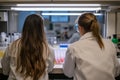 Female scientists conducting experiments in modern laboratory setting