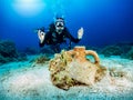Female scuba diver in front of an ancient, sunken in the Aegean Sea
