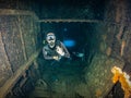 A female scuba diver inside a shipwreck Royalty Free Stock Photo