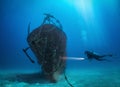 Female scuba diver explores a sunken shipwreck at the Maldives islands Royalty Free Stock Photo