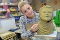 Female sculpter finishing off woman sculpture Royalty Free Stock Photo