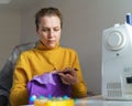 Female seamstress sewing corset while sitting at her creative workplace at home Royalty Free Stock Photo