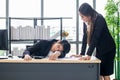 Female secretary awakens the boss to sleep on the work desk Royalty Free Stock Photo