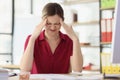 Female secretary massages temples to relieve severe headache