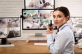 Female security guard with portable transmitter at workplace Royalty Free Stock Photo