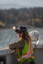Female security officer in a safety vest standing at the BC Ferries ship. Professional Woman Working on the ship