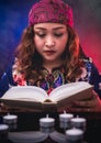 Female seer teller doing psychic reading book