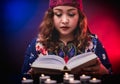 Female seer teller doing psychic reading book