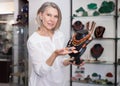 Female seller demonstrates cornelian agate necklace Royalty Free Stock Photo