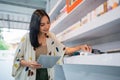 female seller holding the digital tablet while arranging the vape mods