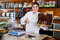 Female seller offering large box of chocolates Royalty Free Stock Photo