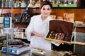 Female seller offering large box of chocolates Royalty Free Stock Photo