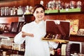 Female seller offering large box of chocolates Royalty Free Stock Photo