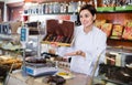 Female seller offering large box of chocolates Royalty Free Stock Photo