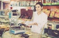 Female seller offering large box of chocolates Royalty Free Stock Photo