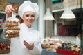 Female seller offering sweets in local confectionery Royalty Free Stock Photo