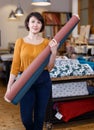 Female seller organizing assortment in fabric store