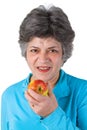 Female senior eating a fresh apple