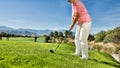 Female senior golfer taking her shot while friends waiting Royalty Free Stock Photo