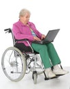Female senior in wheelchair with computer Royalty Free Stock Photo