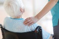 Senior woman in wheelchair with nurse in hospital