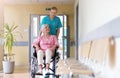 Senior woman in wheelchair with nurse in hospital