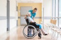 Senior woman in wheelchair with nurse in hospital