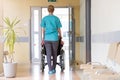 Senior woman in wheelchair with nurse in hospital