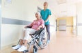 Senior woman in wheelchair with nurse in hospital