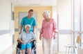 Senior woman in wheelchair with nurse in hospital