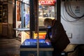 Female Senior Worker, ice cream seller, serving ice cream in the streets of Belgrade wearing a respiratory face mask