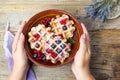 Female serving homemade waffles fresh berry fruit