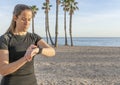 Female setting on her smart watch fitness app .Close up of young beautiful woman check smart watch before workout, lifestyle Royalty Free Stock Photo