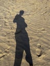 female shadow on yellow river sand