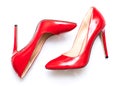 Female shiny red stilettos on a white background Royalty Free Stock Photo