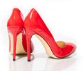 Female shiny red stilettos on a white background Royalty Free Stock Photo