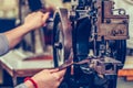 Female shoemaker hands stitching a part of the shoe in the handmade footwear industry