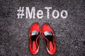 Female shoes on asphalt, hashtag MeToo