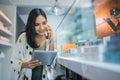 female shopkeeper calling on phone while checking the vape mods stock