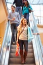 Female Shopper On Escalator In Shopping Mall Royalty Free Stock Photo