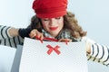 Female with shopping bags against winter light blue background Royalty Free Stock Photo